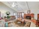 Bright living room featuring a vaulted ceiling, a cozy fireplace, and large windows, creating a comfortable and inviting space at 2974 Lindell Rd, Las Vegas, NV 89146