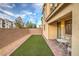 Inviting backyard featuring synthetic grass, patio, and privacy wall, perfect for outdoor gatherings at 3026 Coveri Ct, Las Vegas, NV 89141