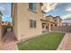 Private backyard oasis with artificial turf and brick-paved pathway, great for relaxing and entertaining at 3026 Coveri Ct, Las Vegas, NV 89141