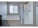 Bathroom with soaking tub, window, and glass-enclosed shower at 3026 Coveri Ct, Las Vegas, NV 89141