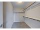 Walk-in closet features carpet and bright white shelving with hanging rods at 3026 Coveri Ct, Las Vegas, NV 89141