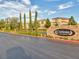 Elegant community entrance with stone signage amidst lush landscaping, creating a welcoming ambiance at 3026 Coveri Ct, Las Vegas, NV 89141