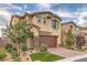 Inviting two-story home with brick driveway, two-car garage, landscaped lawn, and stone veneer at 3026 Coveri Ct, Las Vegas, NV 89141