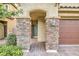 Welcoming front porch featuring stone columns and archway leading to a modern front door at 3026 Coveri Ct, Las Vegas, NV 89141