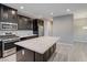 Kitchen featuring dark cabinets, granite countertops, and stainless steel appliances at 3026 Coveri Ct, Las Vegas, NV 89141