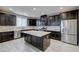 Gourmet kitchen with dark cabinetry, granite countertops, and stainless steel appliances at 3026 Coveri Ct, Las Vegas, NV 89141