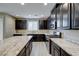 Spacious kitchen boasts dark cabinets, granite countertops, and stainless steel appliances at 3026 Coveri Ct, Las Vegas, NV 89141