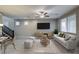 Modern living room featuring neutral tones, sleek furniture, and a ceiling fan at 3026 Coveri Ct, Las Vegas, NV 89141