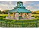 Charming park gazebo with stone pillars, picnic tables, and a decorative clock tower at 3026 Coveri Ct, Las Vegas, NV 89141