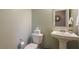 Stylish powder room featuring a pedestal sink, neutral tones, and modern fixtures at 3034 Scenic Rhyme Ave, Henderson, NV 89044