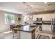 Bright kitchen with stainless steel appliances, white cabinets, and modern pendant lighting at 3034 Scenic Rhyme Ave, Henderson, NV 89044