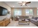 Comfortable living room with tile floors, ceiling fan, and a plush sectional sofa at 3034 Scenic Rhyme Ave, Henderson, NV 89044