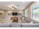 Cozy living room featuring a comfortable sectional sofa, contemporary decor, and plenty of natural light at 3034 Scenic Rhyme Ave, Henderson, NV 89044