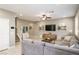 Cozy living room with a comfortable gray sectional sofa, ceiling fan, and decorative shelving at 3034 Scenic Rhyme Ave, Henderson, NV 89044