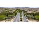 Beautiful street view into the Inspirada community, complete with desert landscaping and well-maintained homes at 3034 Scenic Rhyme Ave, Henderson, NV 89044