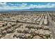 Expansive aerial view of a residential community nestled against a mountain backdrop under a partly cloudy sky at 3516 Bryan Keith Ave, North Las Vegas, NV 89031