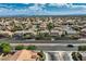 Picture showing a Primary-planned community under a partly cloudy sky and showing houses next to a road at 3516 Bryan Keith Ave, North Las Vegas, NV 89031