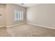 Neutral bedroom with carpet flooring, white trim, and shuttered window at 3516 Bryan Keith Ave, North Las Vegas, NV 89031