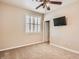 Cozy bedroom with a ceiling fan, window with shutters, and neutral colored walls at 3516 Bryan Keith Ave, North Las Vegas, NV 89031