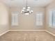 Dining room featuring carpeted flooring, chandelier, and window with shuttered blinds at 3516 Bryan Keith Ave, North Las Vegas, NV 89031