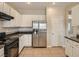 Bright kitchen featuring white cabinetry, stainless steel appliances, and tile flooring at 3516 Bryan Keith Ave, North Las Vegas, NV 89031