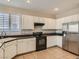 Bright kitchen featuring white cabinetry, stainless steel appliances, and tile flooring at 3516 Bryan Keith Ave, North Las Vegas, NV 89031