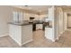 Open kitchen featuring white cabinetry, stainless steel appliances, and breakfast bar at 3516 Bryan Keith Ave, North Las Vegas, NV 89031