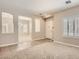 Open-concept living room and dining area featuring neutral paint and carpet at 3516 Bryan Keith Ave, North Las Vegas, NV 89031