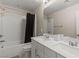 Modern bathroom featuring double sinks, a large mirror, and a shower-tub combination with a white tile surround at 356 Free Fall Ave, North Las Vegas, NV 89084