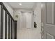 Inviting foyer featuring tiled flooring, staircase with black banister, and access to other rooms at 356 Free Fall Ave, North Las Vegas, NV 89084