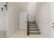 Entryway featuring tiled floors, white walls, and a staircase with a metal railing and carpet at 356 Free Fall Ave, North Las Vegas, NV 89084