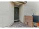 Front entry featuring a gray front door, brick paver walkway, and exterior stucco wall texture at 356 Free Fall Ave, North Las Vegas, NV 89084