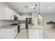 Well-lit kitchen with granite countertops, a stainless steel refrigerator, and modern pendant lights at 356 Free Fall Ave, North Las Vegas, NV 89084