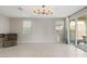 Open living room with tiled floors, neutral walls, and a sliding glass door that leads to the patio at 356 Free Fall Ave, North Las Vegas, NV 89084