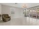 Bright living room with tile flooring, a ceiling fan, and sliding glass doors to the patio at 356 Free Fall Ave, North Las Vegas, NV 89084