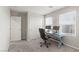 Bright, carpeted office space featuring a window, modern desk setup, and comfortable chair at 356 Free Fall Ave, North Las Vegas, NV 89084