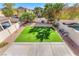 Spacious backyard featuring a perfectly manicured lawn area, desert landscaping, and a private pool at 3645 Bella Legato Ave, North Las Vegas, NV 89081