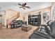 Open-concept living area featuring tile flooring, a staircase, and comfortable seating at 3645 Bella Legato Ave, North Las Vegas, NV 89081