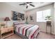 Comfortable bedroom with a double bed, bedside table, ceiling fan, and natural light from a window at 3681 Via Sonja Ave, Las Vegas, NV 89115