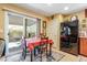 Cozy dining area with a table set for four, adjacent to the kitchen and patio access at 3681 Via Sonja Ave, Las Vegas, NV 89115