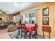 Cozy dining area with a table set for four, adjacent to the living room and kitchen at 3681 Via Sonja Ave, Las Vegas, NV 89115