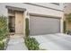 Close up of charming two-story home featuring a well-manicured front yard and a two-car garage at 3681 Via Sonja Ave, Las Vegas, NV 89115