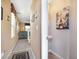 Inviting hallway with neutral tones, leading to a powder room and a cozy living area at 3681 Via Sonja Ave, Las Vegas, NV 89115