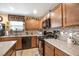 Close up of kitchen featuring granite countertops, tiled backsplash, and black appliances at 3681 Via Sonja Ave, Las Vegas, NV 89115