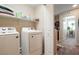 Functional laundry room with modern washer and dryer, complemented by a convenient storage shelf at 3681 Via Sonja Ave, Las Vegas, NV 89115