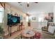 Upstairs living area with a comfortable sofa, TV, plants, and a view of the staircase and landing at 3681 Via Sonja Ave, Las Vegas, NV 89115