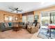 Comfortable living room featuring a cozy sectional sofa, ceiling fan and natural light at 3681 Via Sonja Ave, Las Vegas, NV 89115