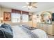 Bright main bedroom features a large bed, dresser, decorative mirror, and windows for natural light at 3681 Via Sonja Ave, Las Vegas, NV 89115