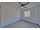 This bedroom features carpet, a window, ceiling fan, and outlets at 382 E Erin St # 2, Pahrump, NV 89048