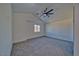 Empty bedroom featuring a modern ceiling fan, neutral carpet, and a window with natural light at 382 E Erin St # 2, Pahrump, NV 89048